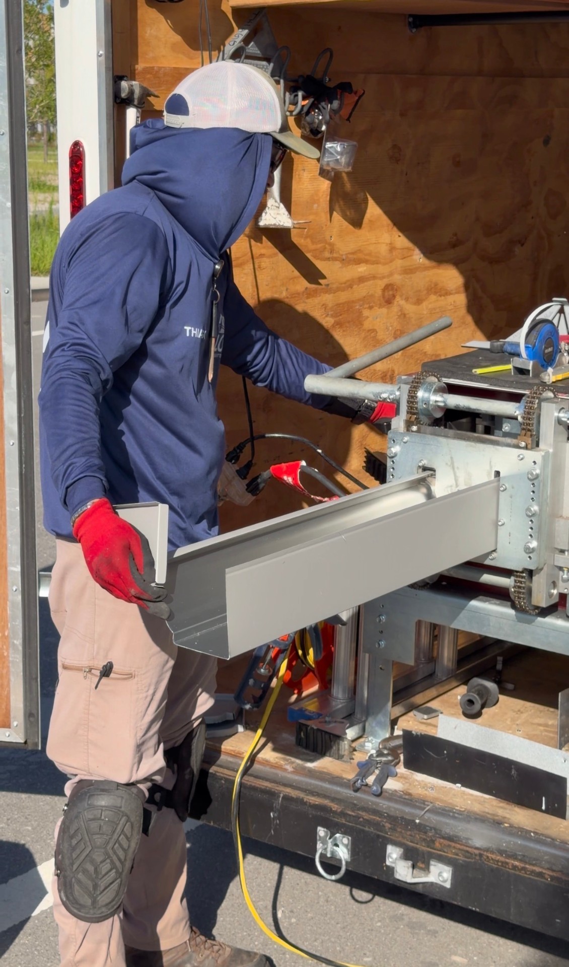 Lov Gutters technician custom fabricating a seamless gutter on-site